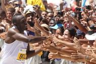 Jamaican runner Usain Bolt greets the public at the end of a race in Copacabana Beach in Rio on March 31, 2013
